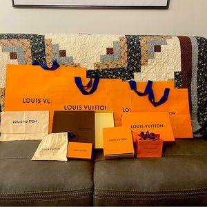 Several Louis Vuitton bags, boxes and dusters